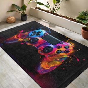 Peut inclure: Un design abstrait et coloré d'une manette de jeu vidéo sur fond noir. La manette est peinte dans des tons de rose, bleu, jaune et orange.