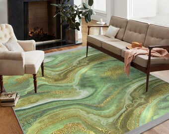 May include: Green and gold abstract area rug with a marbleized design. The rug has a gray border and is shown in a living room setting.