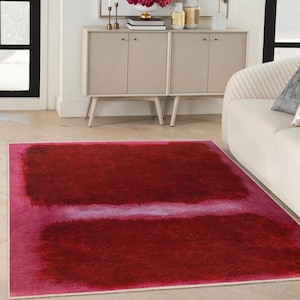 Pode incluir: Um tapete abstrato vermelho e rosa com uma borda branca. O tapete tem uma textura macia e um design moderno.