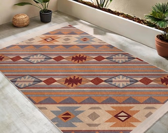 May include: A beige, orange, and blue patterned rug with a geometric design. The rug has a white border.