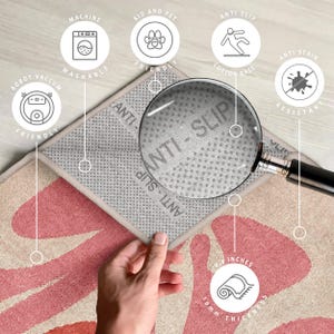 May include: A pink and beige patterned rug with a grey anti-slip backing. The rug is 10 cm thick and has a non-slip backing. The rug is machine washable and robot vacuum friendly. The rug is also kid and pet friendly and anti-stain resistant.