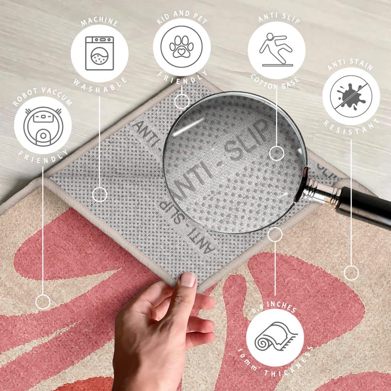 May include: A pink and beige patterned rug with a grey anti-slip backing. The rug is 10 cm thick and has a non-slip backing. The rug is machine washable and robot vacuum friendly. The rug is also kid and pet friendly and anti-stain resistant.