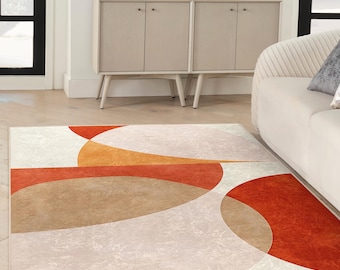 May include: A modern area rug with a geometric design featuring overlapping circles in shades of orange, brown, and red on a white background.