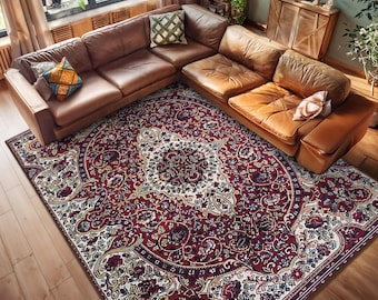 May include: A burgundy and cream patterned area rug with a floral design. The rug is laid out on a hardwood floor in a living room with a brown leather sectional sofa.