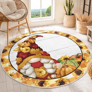 May include: Circular rug with a seasonal autumn design. It features a gnome wearing a hat made of leaves and pumpkins. The border has sunflowers and a yellow and white checked pattern.