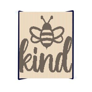 May include: A wooden sign with a bee illustration and the word "kind" in a stylized font.