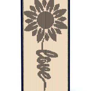 May include: A book with a blue cover and a black sunflower design on the front. The sunflower is made of lines and is stylized.