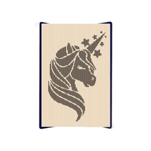 May include: A black and white silhouette of a unicorn's head with a star-shaped horn and mane. The image is on a light brown background.