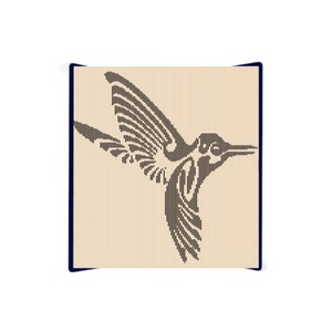 May include: A detailed illustration of a hummingbird in flight, rendered in dark brown lines against a light beige background. The bird's wings are spread, showcasing intricate feather detail. The artwork is framed with a dark blue border.