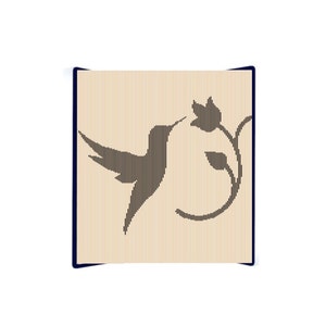 May include: A black silhouette of a hummingbird with its beak in a flower on a light brown background.