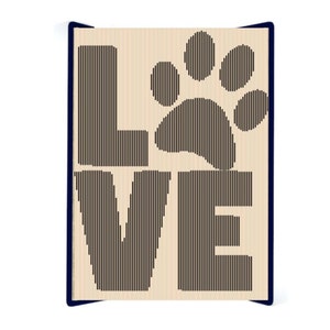 May include: A beige wood sign with the word "LOVE" spelled out in black vertical lines. A paw print is in the center of the sign, also made of black vertical lines.