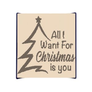 May include: A beige card with a black stylized Christmas tree and the text "All I Want For Christmas Is You".