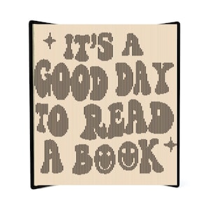 May include: A beige book cover with black text that reads "It's a good day to read a book". The text is in a retro font style with a star on either side.