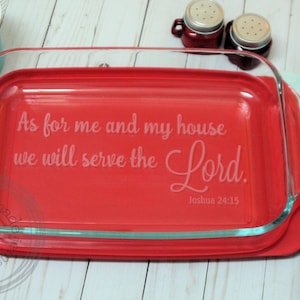May include: A red glass baking dish with a white inscription that reads "As for me and my house we will serve the Lord. Joshua 24:15".