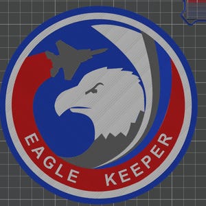 May include: Embroidered patch with a circular design featuring a gray eagle head, a gray jet, and the words "EAGLE KEEPER" in white. The patch has a blue center, a red outer ring, and a gray border.