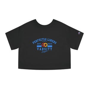 May include: Black cropped t-shirt with a blue and white varsity style logo that says "Perfectio Liners Est. 2024 Varsity League" with two interlocking gears in red, yellow, and blue.