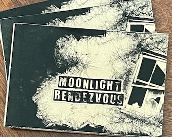 May include: Three stacked, square cards with a black and white design. The cards feature a distressed image of a building and tree branches. The text "MOONLIGHT RENDEZVOUS" is printed on a white rectangle.