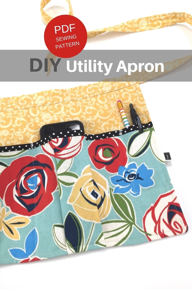 May include: A DIY utility apron with a floral print featuring red, yellow, and blue roses on a light blue background. The apron has multiple pockets, including a large pocket for a phone and smaller pockets for pens and pencils. The apron is made from fabric with a yellow floral pattern.