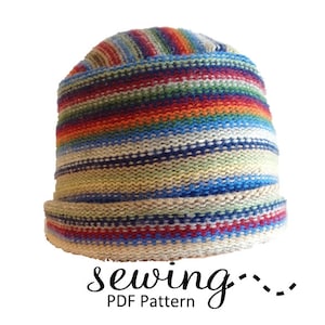 May include: A colorful striped knit hat with a beige brim. The hat is made with a variety of colors, including red, orange, yellow, green, blue, and white. The hat is a sewing pattern.