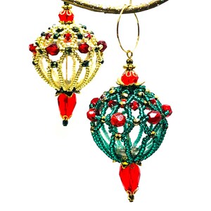 May include: Two beaded Christmas baubles, one with a white and gold base and red accents, and the other with a green base and red accents.