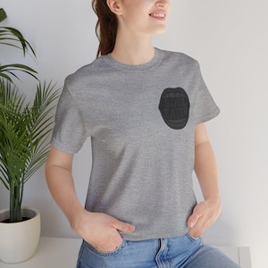 May include: A heather gray t-shirt featuring a black graphic of an open mouth with the text "SOUL EATER" inside. The shirt is a crew neck style and is made of a soft material.