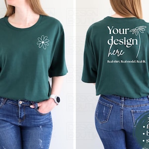 May include: A dark green t-shirt with a daisy graphic on the front and the text "Your design here" on the back. The shirt is paired with blue jeans. The image shows the front and back of the shirt.