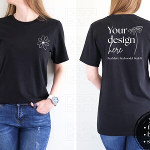 Puede incluir: Camiseta negra con un gráfico de margarita blanca en la parte delantera y el texto "Your design here" en la parte trasera. La camiseta también tiene el texto "Real shirt. Real model. Real fit." La imagen muestra la parte delantera y trasera de la camiseta.