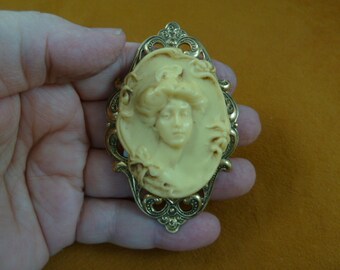 Woman Gibson Girl style hair in bun flowers bow trim ivory Cameo scrolled heart brass pin pendant brooch CL66-2