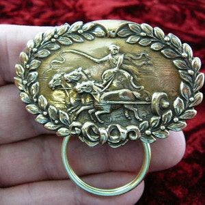 Man with chariot team of horses oval flower trimmed brass Eyeglass glasses holder id badge pin brooch E-529