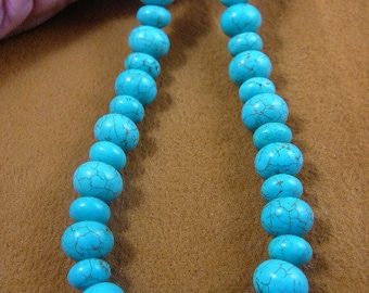May include: A turquoise beaded necklace with a light blue color. The beads are round and have a slightly irregular shape. The necklace is made of natural turquoise stones.