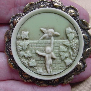 CHERUB helping another cherub angel over stone wall fence into grape vineyard CAMEO pin pendant  brass brooch cm116-2