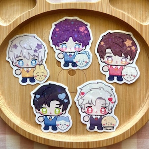 May include: Five die-cut stickers featuring chibi-style characters with large eyes and sparkling hair, each accompanied by a small animal companion. The stickers have a holographic finish with star and heart patterns throughout the designs.