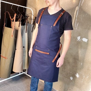 Apron for men. Cotton canvas with cross-back leather straps.