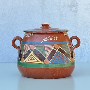 May include: A handmade, wooden cutting board with a natural finish. The rectangular board features a juice groove and a handle. Dimensions are approximately 18 inches long, 12 inches wide, and 1 inch thick.