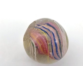 May include: A clear glass marble with colorful internal swirls. The marble features pink, blue, yellow, and black stripes, creating a vibrant and unique pattern. The marble is a classic toy.