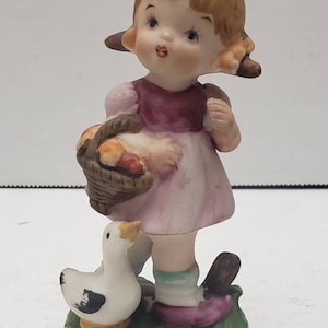 Vintage  girl with duck figurine Japan with sticker