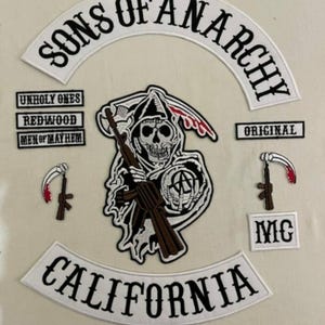 May include: A set of Sons of Anarchy motorcycle club patches. The patches are white with black lettering and include the words "Sons of Anarchy", "Original", "MC", "California", "Unholy Ones", "Redwood", and "Men of Mayhem". There is also a patch featuring a grim reaper holding a rifle.