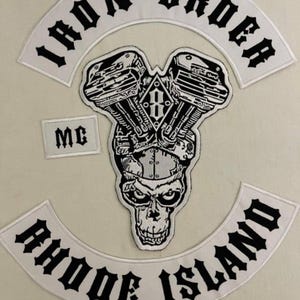 May include: White embroidered patches with black lettering. The patches read "Iron Order MC Rhode Island". There is also a patch with a black and white illustration of a motorcycle engine.