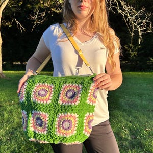 colorful granny square crossbody bag,handmade crochet shoulder bag adjustable,vintage circular flower bag leather strap,boho crossbody bag lined,retro granny square purse handmade,adjustable leather strap shoulder bag,festival crossbody bag colorful,lined crochet bag secure closure,gift for her crossbody bag,vintage style shoulder bag handmade,bright granny square bag,hands free crossbody crochet,travel bag adjustable strap,unique handmade purse granny square,sustainable fashion crossbody bag