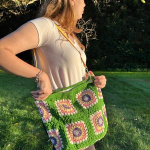 colorful granny square crossbody bag,handmade crochet shoulder bag adjustable,vintage circular flower bag leather strap,boho crossbody bag lined,retro granny square purse handmade,adjustable leather strap shoulder bag,festival crossbody bag colorful,lined crochet bag secure closure,gift for her crossbody bag,vintage style shoulder bag handmade,bright granny square bag,hands free crossbody crochet,travel bag adjustable strap,unique handmade purse granny square,sustainable fashion crossbody bag