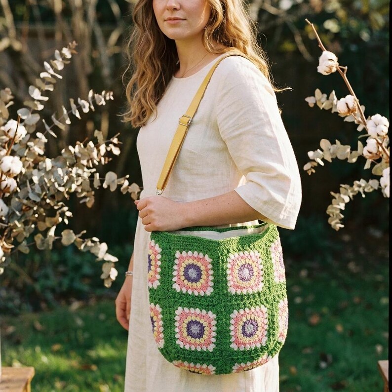 colorful granny square crossbody bag,handmade crochet shoulder bag adjustable,vintage circular flower bag leather strap,boho crossbody bag lined,retro granny square purse handmade,adjustable leather strap shoulder bag,festival crossbody bag colorful,lined crochet bag secure closure,gift for her crossbody bag,vintage style shoulder bag handmade,bright granny square bag,hands free crossbody crochet,travel bag adjustable strap,unique handmade purse granny square,sustainable fashion crossbody bag