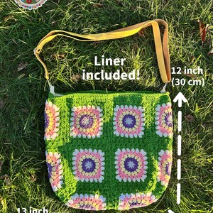 colorful granny square crossbody bag,handmade crochet shoulder bag adjustable,vintage circular flower bag leather strap,boho crossbody bag lined,retro granny square purse handmade,adjustable leather strap shoulder bag,festival crossbody bag colorful,lined crochet bag secure closure,gift for her crossbody bag,vintage style shoulder bag handmade,bright granny square bag,hands free crossbody crochet,travel bag adjustable strap,unique handmade purse granny square,sustainable fashion crossbody bag