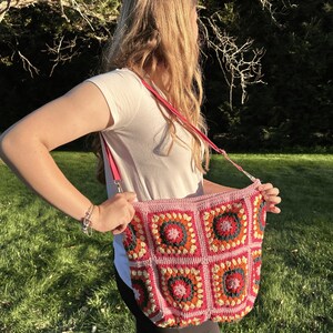 colorful granny square crossbody bag,handmade crochet shoulder bag adjustable,vintage circular flower bag leather strap,boho crossbody bag lined,retro granny square purse handmade,adjustable leather strap shoulder bag,festival crossbody bag colorful,lined crochet bag secure closure,gift for her crossbody bag,vintage style shoulder bag handmade,bright granny square bag,hands free crossbody crochet,travel bag adjustable strap,unique handmade purse granny square,sustainable fashion crossbody bag