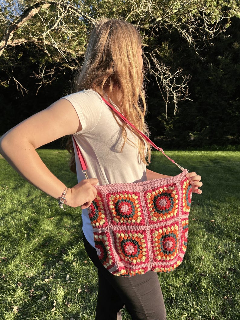 colorful granny square crossbody bag,handmade crochet shoulder bag adjustable,vintage circular flower bag leather strap,boho crossbody bag lined,retro granny square purse handmade,adjustable leather strap shoulder bag,festival crossbody bag colorful,lined crochet bag secure closure,gift for her crossbody bag,vintage style shoulder bag handmade,bright granny square bag,hands free crossbody crochet,travel bag adjustable strap,unique handmade purse granny square,sustainable fashion crossbody bag