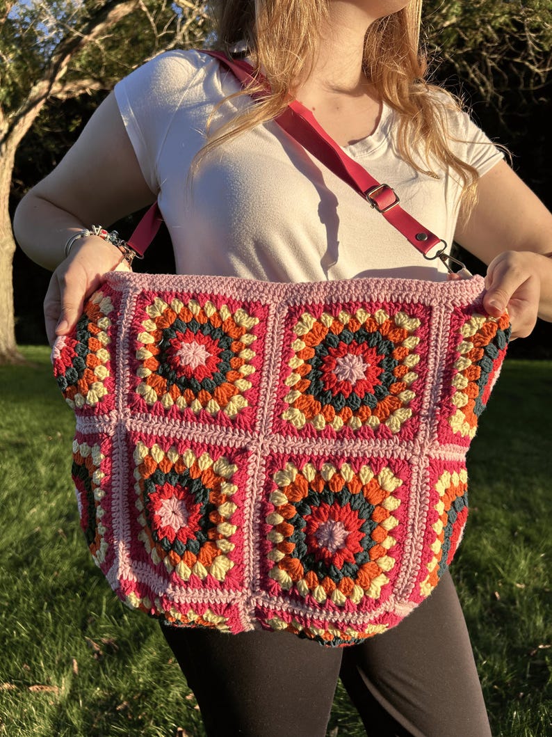 colorful granny square crossbody bag,handmade crochet shoulder bag adjustable,vintage circular flower bag leather strap,boho crossbody bag lined,retro granny square purse handmade,adjustable leather strap shoulder bag,festival crossbody bag colorful,lined crochet bag secure closure,gift for her crossbody bag,vintage style shoulder bag handmade,bright granny square bag,hands free crossbody crochet,travel bag adjustable strap,unique handmade purse granny square,sustainable fashion crossbody bag