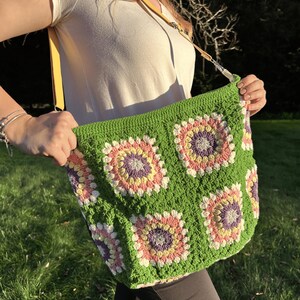 colorful granny square crossbody bag,handmade crochet shoulder bag adjustable,vintage circular flower bag leather strap,boho crossbody bag lined,retro granny square purse handmade,adjustable leather strap shoulder bag,festival crossbody bag colorful,lined crochet bag secure closure,gift for her crossbody bag,vintage style shoulder bag handmade,bright granny square bag,hands free crossbody crochet,travel bag adjustable strap,unique handmade purse granny square,sustainable fashion crossbody bag