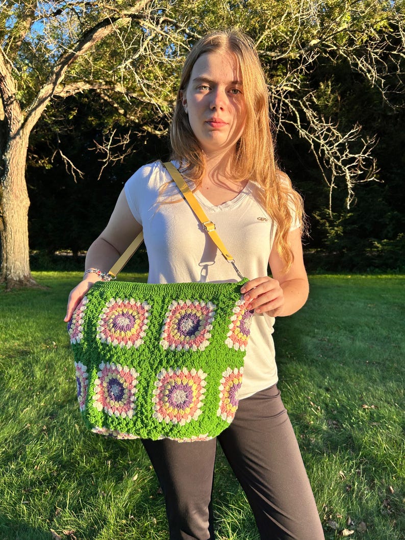 colorful granny square crossbody bag,handmade crochet shoulder bag adjustable,vintage circular flower bag leather strap,boho crossbody bag lined,retro granny square purse handmade,adjustable leather strap shoulder bag,festival crossbody bag colorful,lined crochet bag secure closure,gift for her crossbody bag,vintage style shoulder bag handmade,bright granny square bag,hands free crossbody crochet,travel bag adjustable strap,unique handmade purse granny square,sustainable fashion crossbody bag