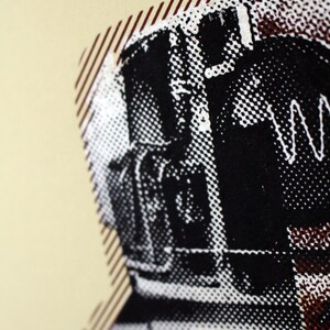May include: Close-up of a black and white graphic art print. The image features a detailed, halftone-style illustration of a figure, possibly a person or object, with a white zigzag line. The background is a light beige color.