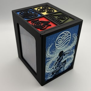 May include: Black box featuring four elemental symbols on the top in blue, yellow, red, and green. The side panel displays a blue and white graphic of a water bender. The box has a clear window on one side.
