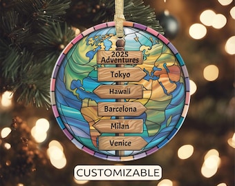 May include: A round, customizable Christmas ornament with a stained-glass design of the Earth. The ornament features wooden signposts pointing to Tokyo, Hawaii, Barcelona, Milan, and Venice. The text "2025 Adventures" is above the signs, and "CUSTOMIZABLE" is at the bottom.